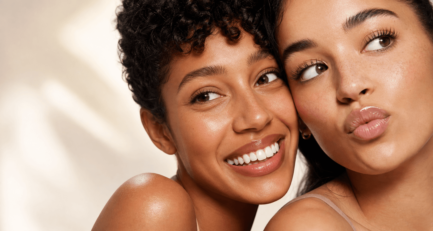 Two women with confident glowing skin in a skincare campaign close-up